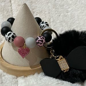 Keychain Wristlet. 
Silicone beaded bracelet with a black Pom Pom.